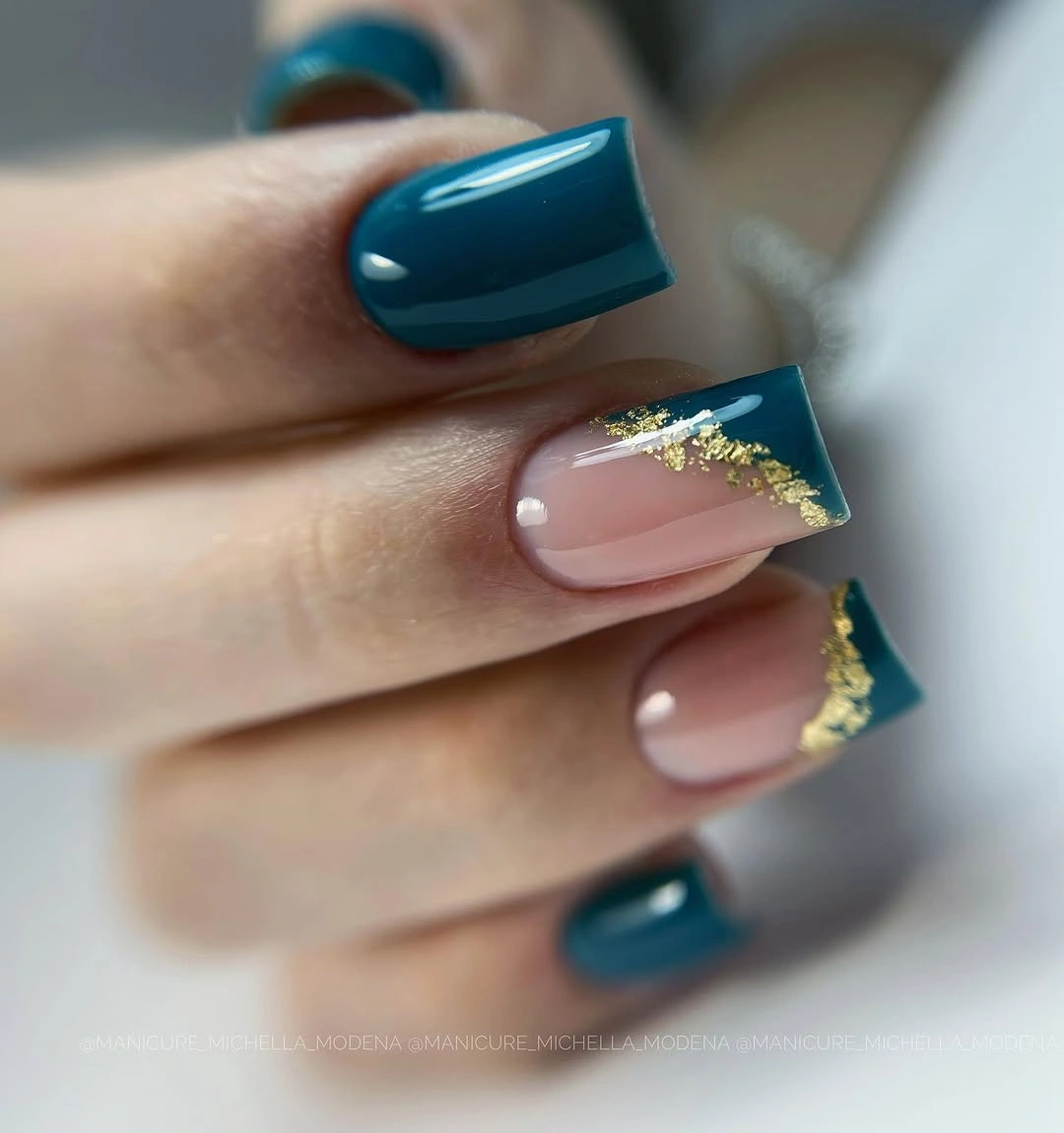 Glossy teal square nails with nude sections and gold-colored flecked tips