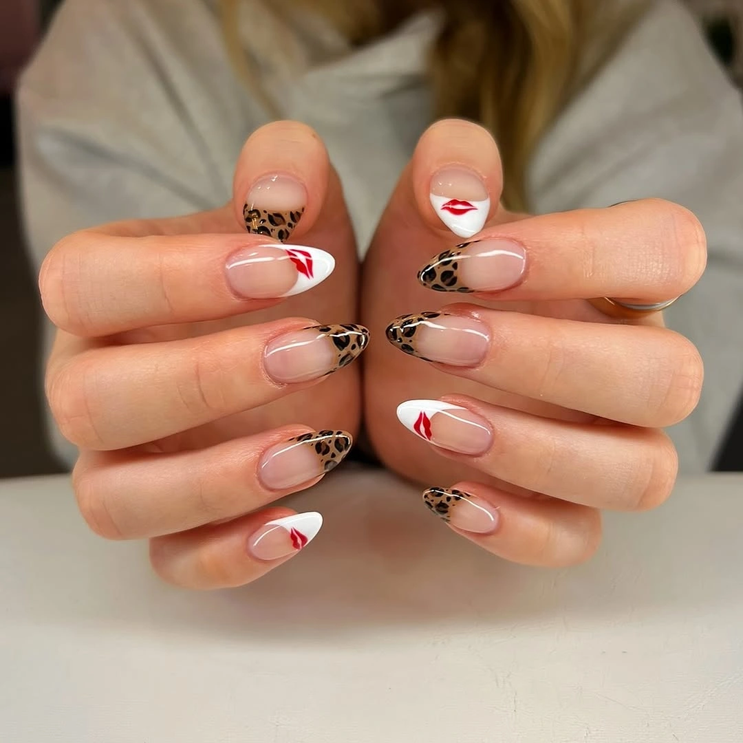Nude almond nails with leopard French tips and red lips on white tips