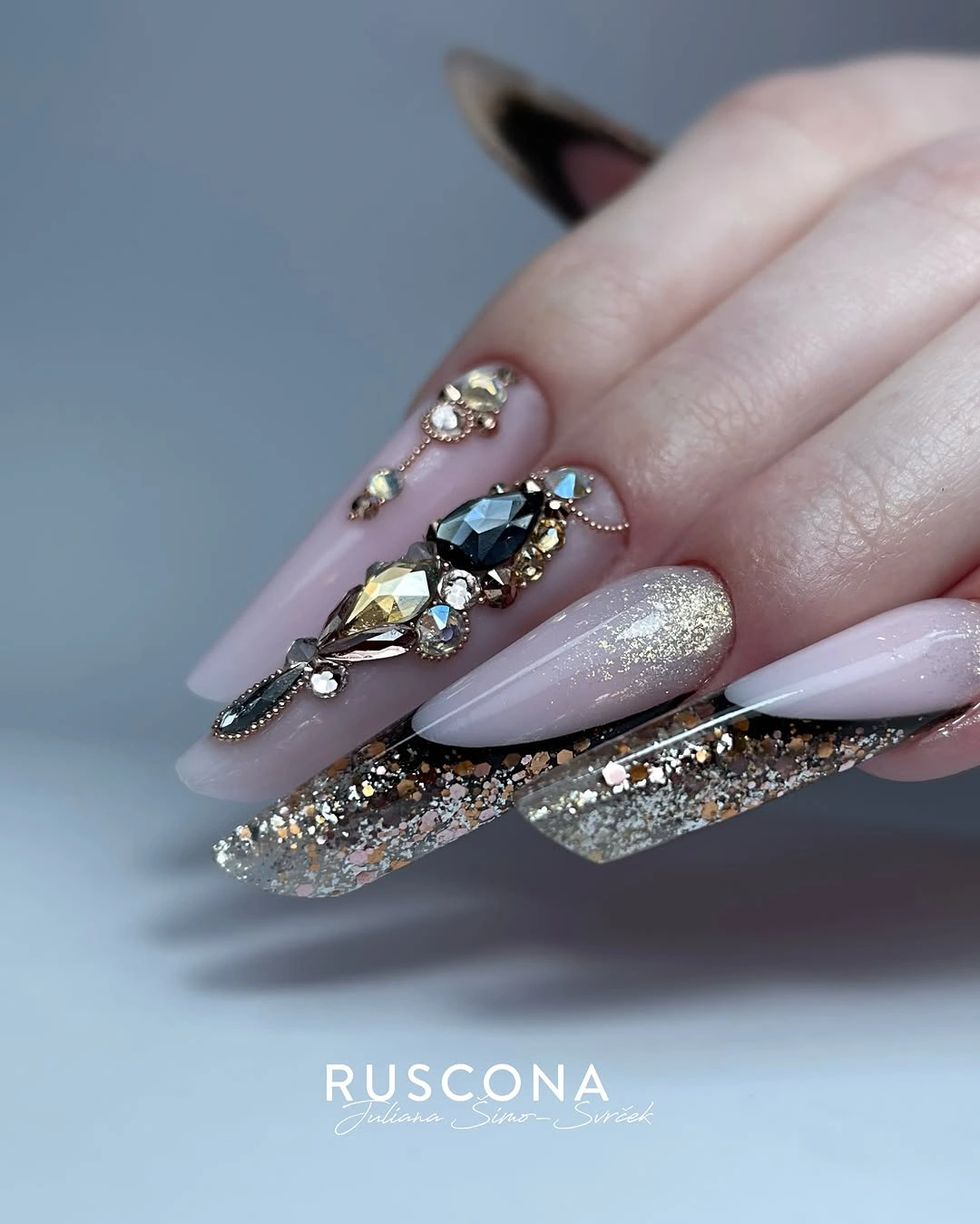 Long tapered square nails with silver glitter and large faceted jewel-like accents