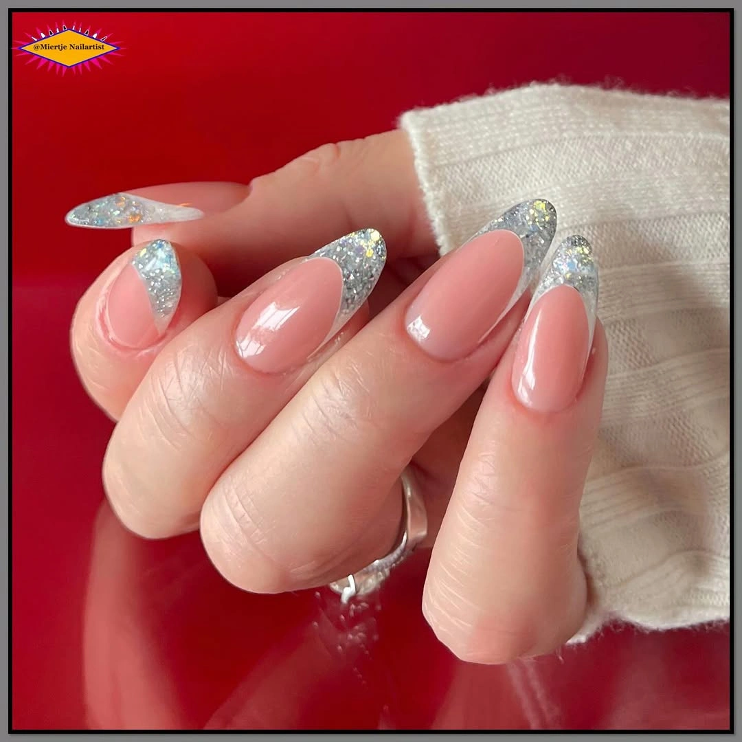 Long pink almond nails with angled silver glitter French tips