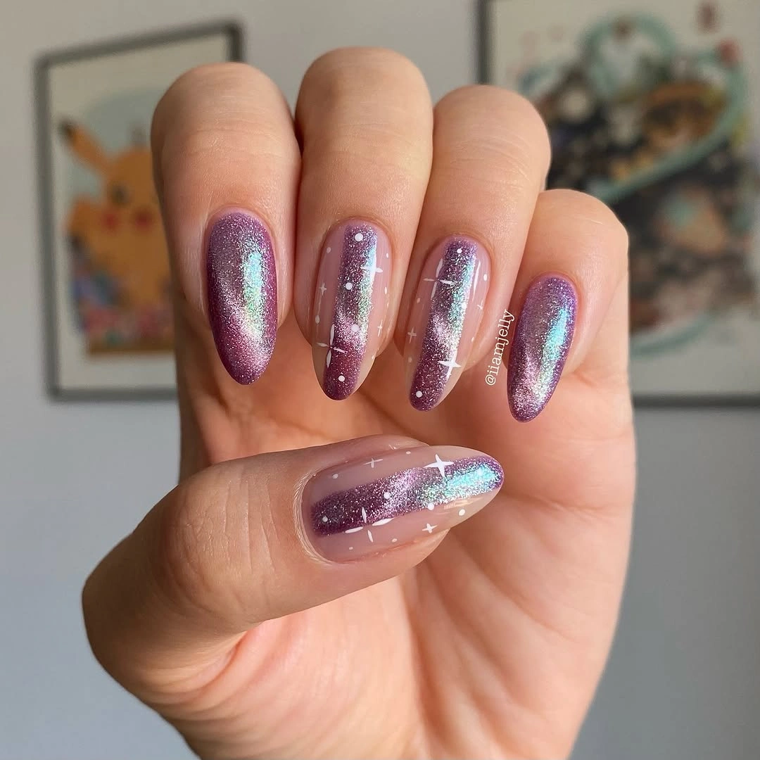 Long almond nails with purple shimmer, turquoise reflections and small white stars