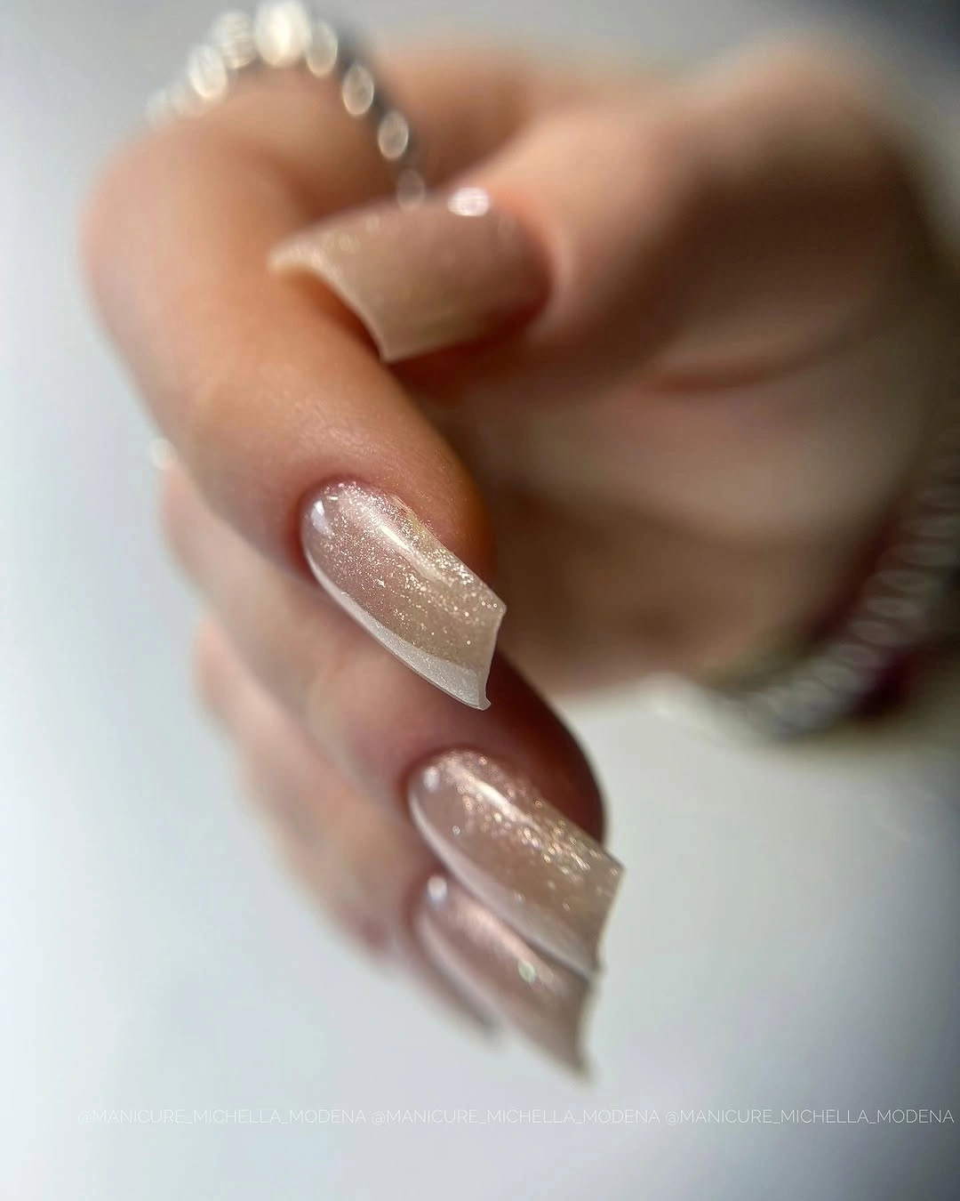 Medium square nails covered in fine champagne and silvery shimmer