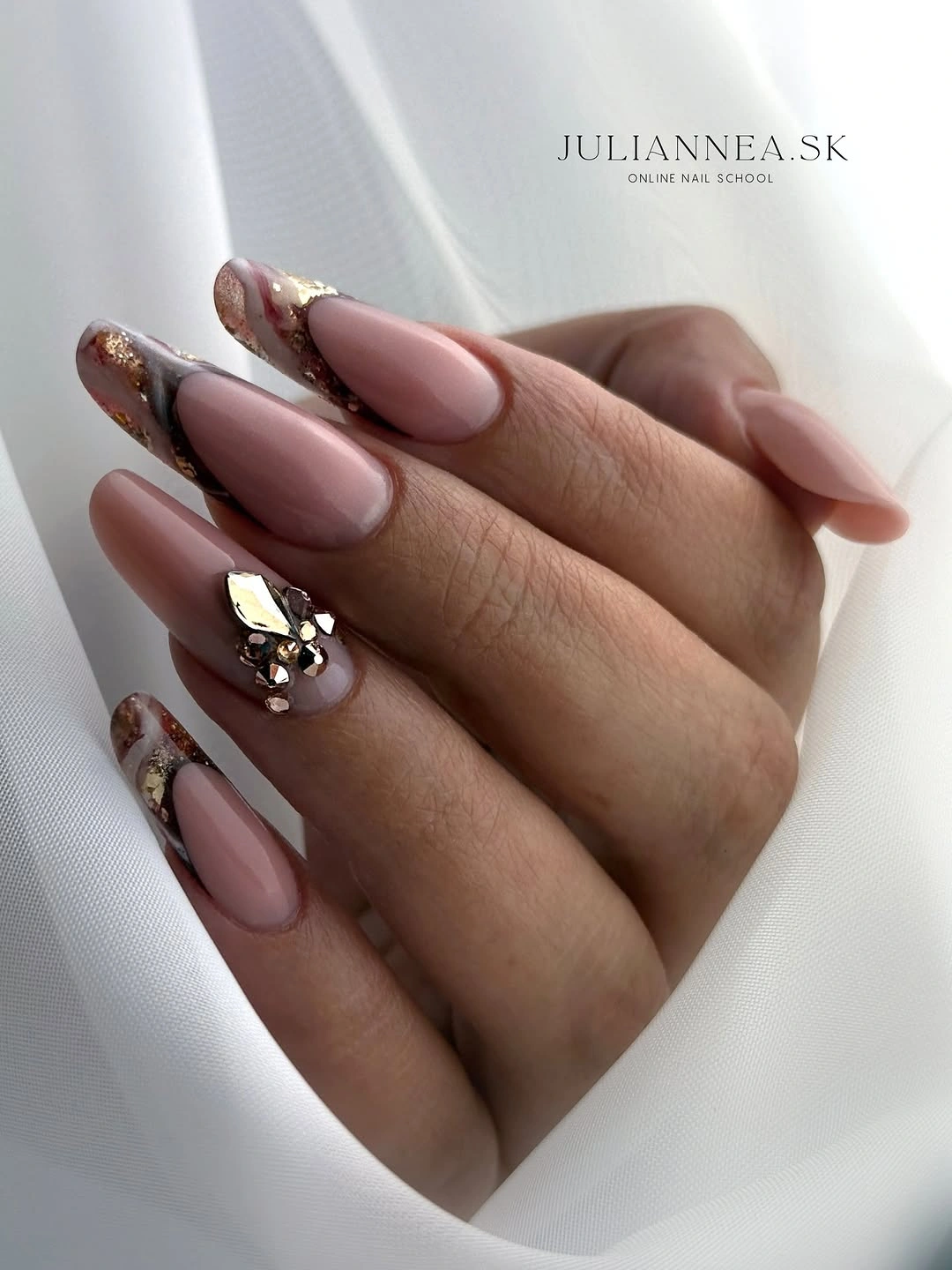 Long pink almond nails with bronze gold edges and clustered reflective accent