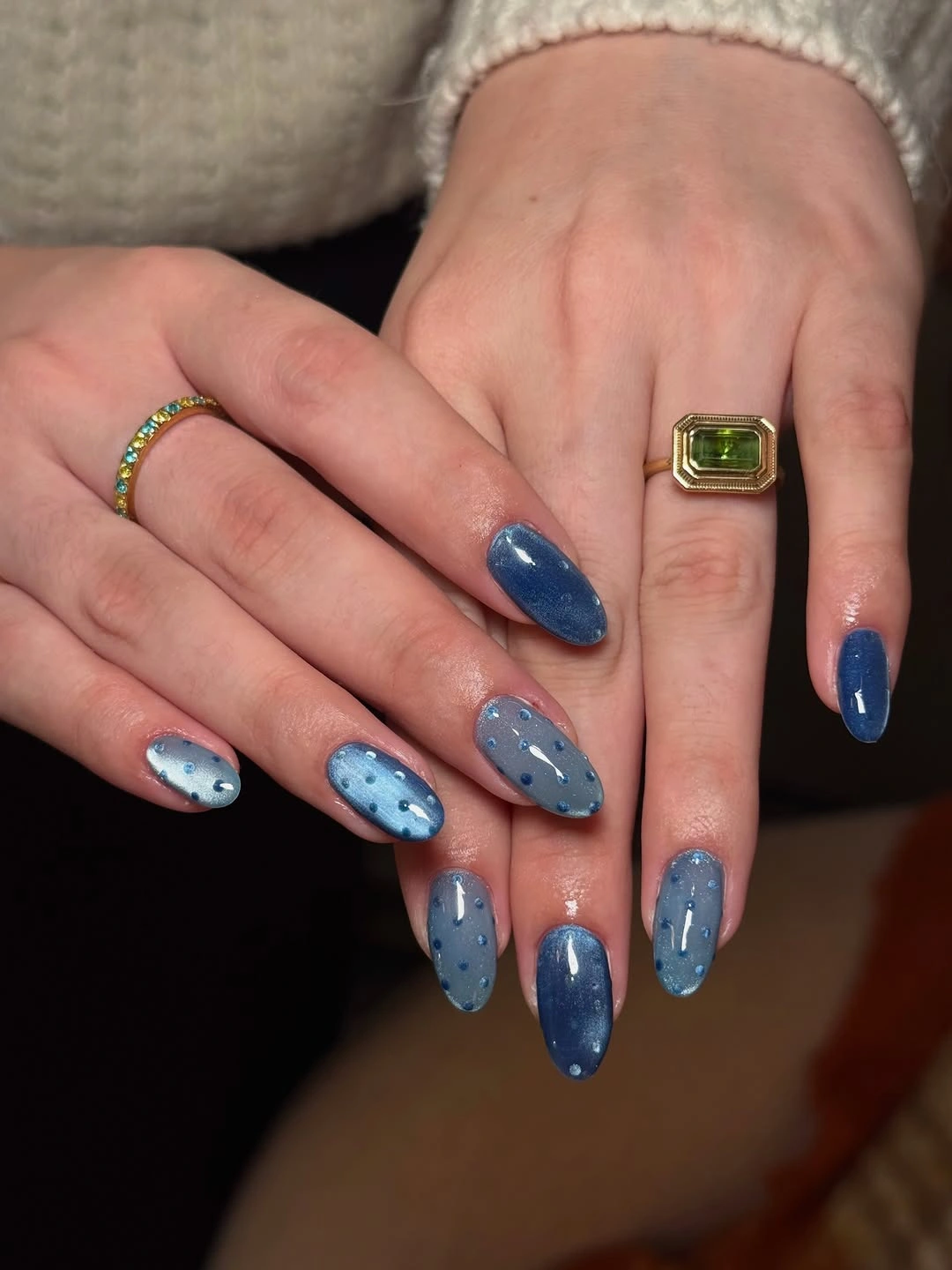 Blue almond nails with navy accents pale blue surfaces and tiny dots