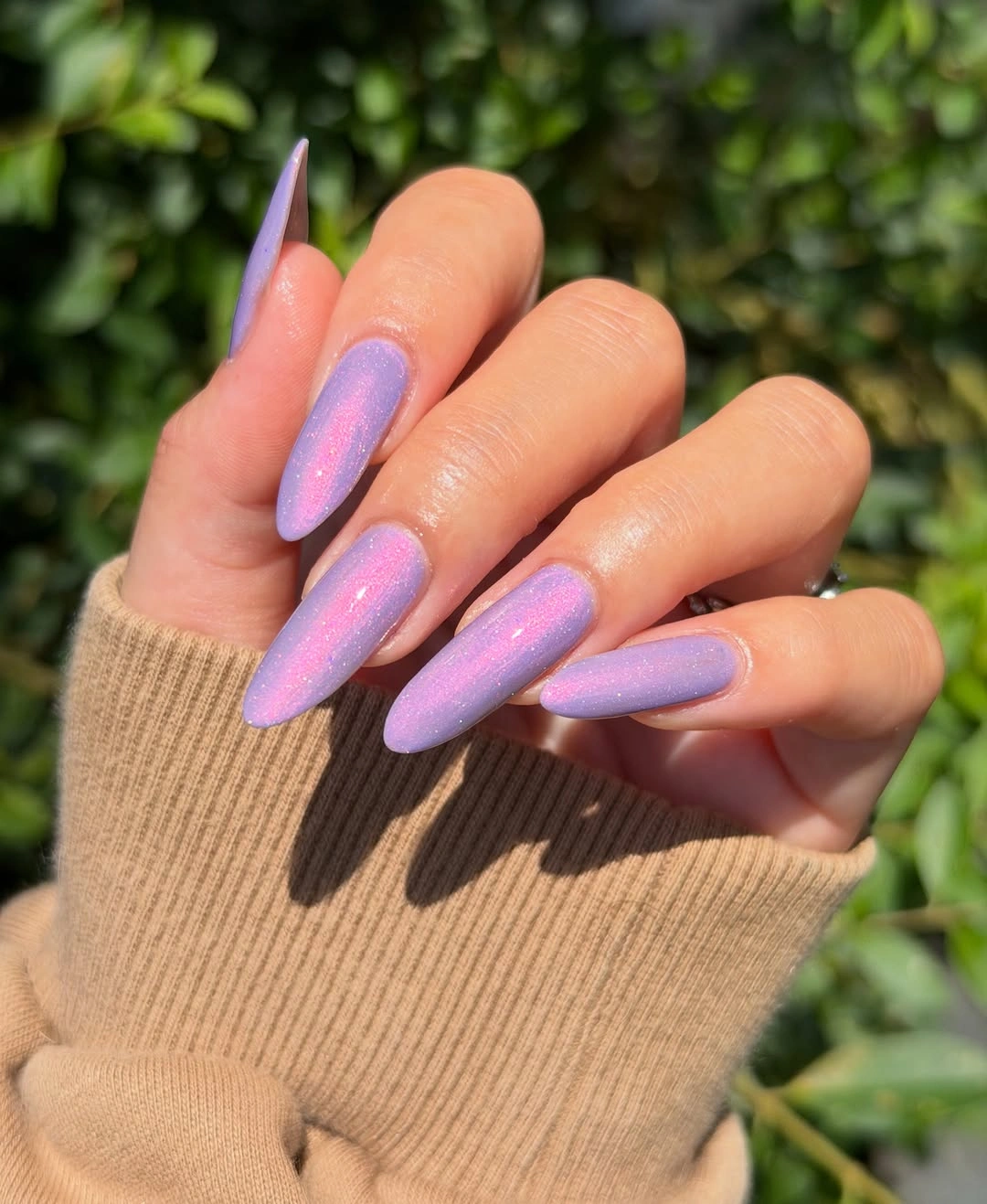 Long lavender almond nails with fine shimmer and pink reflected highlights