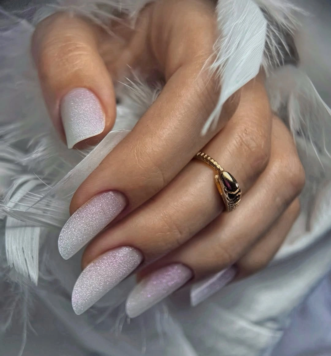 Long almond nails with pale pink white color and fine frosted shimmer